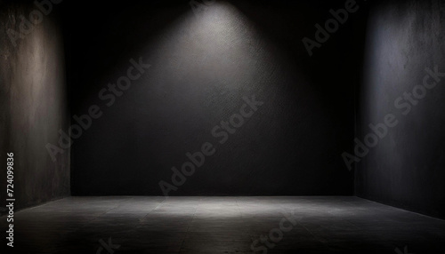 Photographie A solitary spotlight shines on an empty black room, suitable for text mockup or product presentation