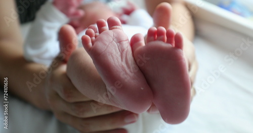 Baby newborn feet together after birth, frst days of life