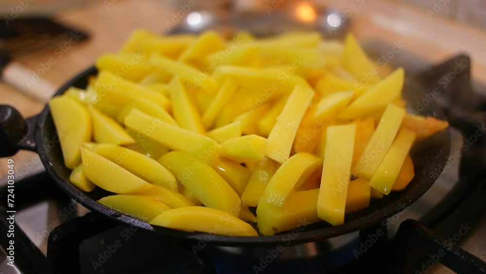 fried potatoes in a pan. Frying fresh potatoes in a frying pan with sunflower oil. Fried