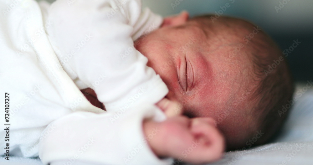 Baby newborn waking up from nap stretching body Baby newborn waking up from nap stretching body