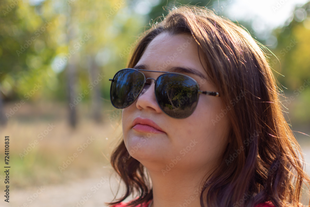 Face of woman in sunglasses in park Face of woman in sunglasses in park