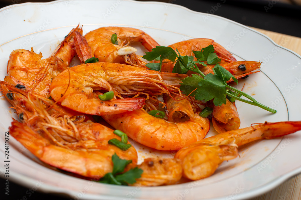 Delicious juicy shrimp in a plate with parsley leaves Delicious juicy shrimp in a plate with parsley leaves