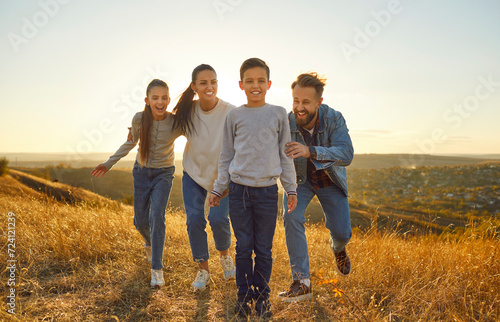 Family basks in the joys of nature during a leisurely vacation or weekend. With smiles on faces, share time together, walking amidst scenic nature, creating enduring portraits of cherished moments.
