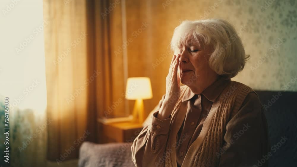 Lonely elderly woman crying at home, pain of loss, emotional stress, crisis Lonely elderly woman crying at home, pain of loss, emotional stress, crisis
