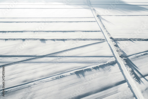 Chilled Silence: Aerial Shot of Snow-Covered Terrain and Shadows