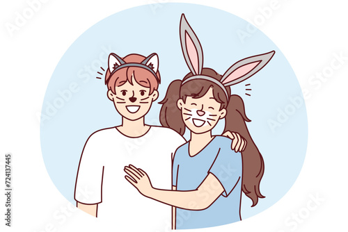 Boy and girl stand hugging with fake animal ears and painted mustaches on faces for homparty or school masquerade. Happy children pretend to be rabbit and cat to spectacle. Flat vector design