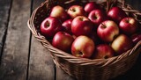 freshly picked red apples in a basket on a wooden table, copy space for text
