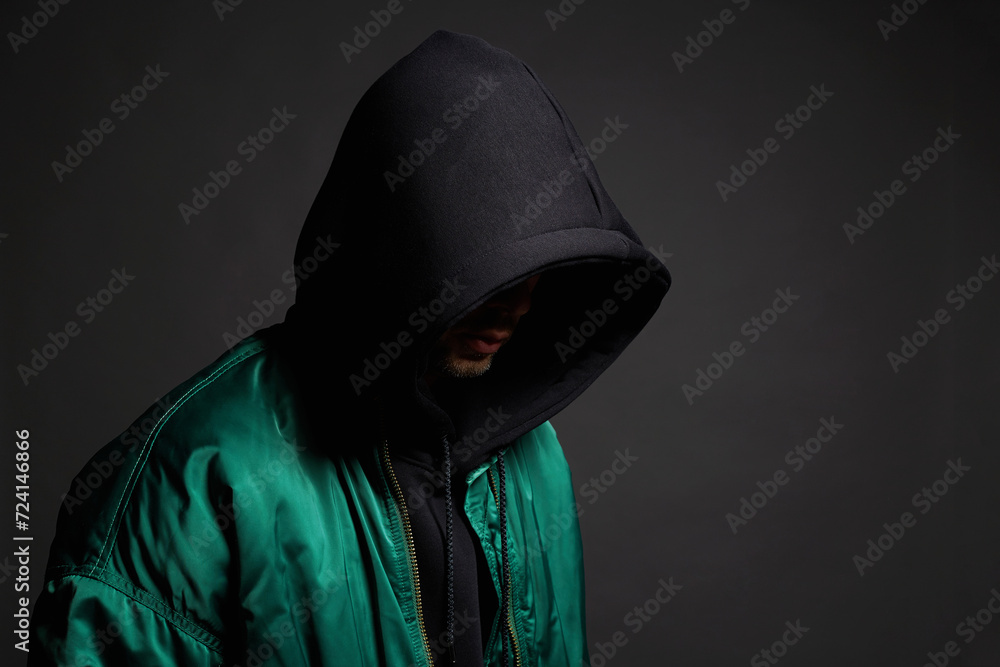Man in Black Hood and green bomber jacket. Boy in a hooded sweatshirt Man in Black Hood and green bomber jacket. Boy in a hooded sweatshirt