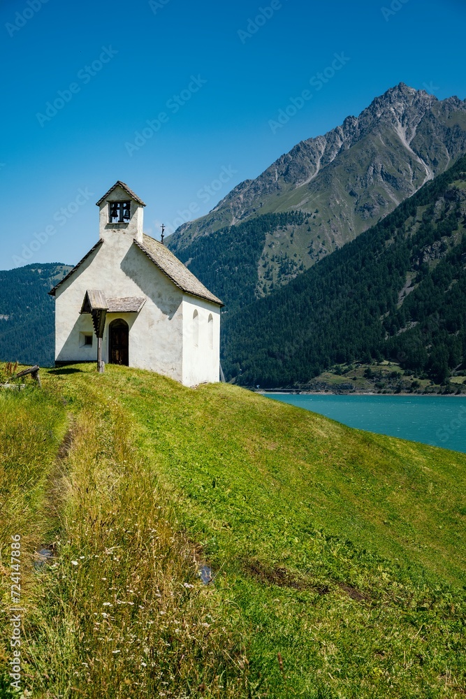 The small white church on the shore of Lake Resia in South Tyrol