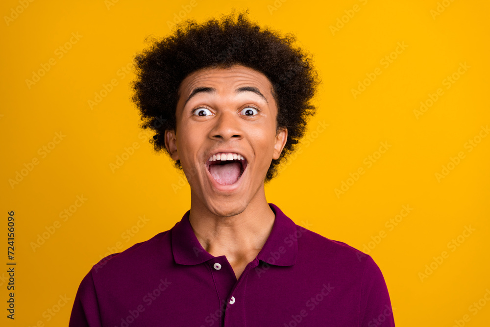 Photo of cheerful positive glad man open mouth wear magenta polo wow offer isolated on yellow color background Photo of cheerful positive glad man open mouth wear magenta polo wow offer isolated on yellow color background