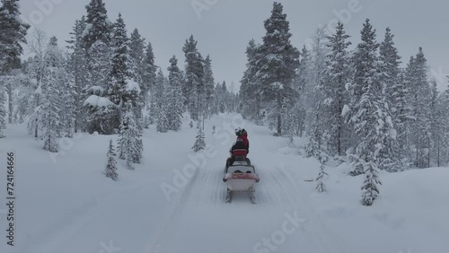 Drone-tracked snowmobile safari in Urho Kekkonen Park in Finland