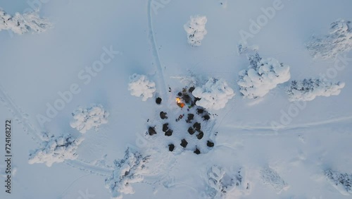 Drone view of a group of hikers around a campfire in finnish lapland 