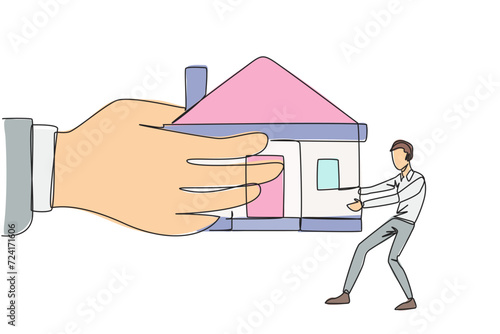 Continuous one line drawing young businessman pulling miniature house which is also pulled by a big hand. Failed to pay the mortgage so that it can be withdrawn by bank. Single line draw design vector