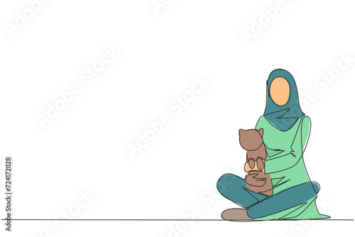 Single one line drawing of young Arabian woman sitting cross-legged hugging a little cat. She loves the cat because it has been taken care of since the cat was born. Continuous line design graphic