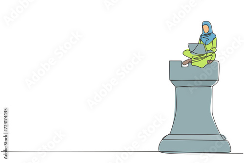 One single line drawing Arabian businesswoman sitting on giant rook piece chess while holding on laptop computer. Playing chess games online. Metaphor of victory of business. Continuous line design
