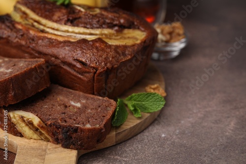 Delicious banana bread on brown table, closeup. Space for text