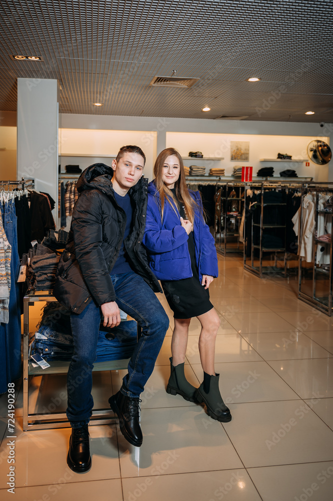 Fototapeta premium A man and a woman posing for a picture indoors. They are both smiling and standing. 5919