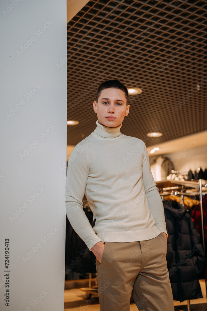 The image is of a man standing in a room, wearing trousers and a shirt. 5935 The image is of a man standing in a room, wearing trousers and a shirt. 5935