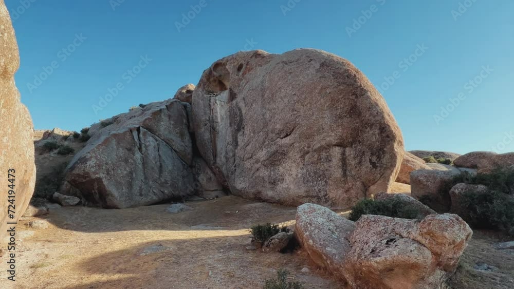 The Valley of Demons in Uzbekistan in the Samarkand region. Boulders, granite sculptures, huge boulders of bizarre shapes in the spurs of the Zaravshansky ridge. 4K Video