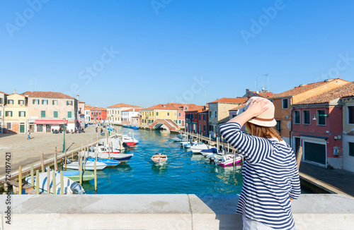 Happy  traveler woman having fun on well known Murano island near Venice. Travel and vacation in Italy concept