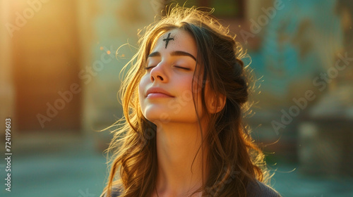 Fotografie, Obraz Girl with cross made from ash on forehead. Ash wednesday concept