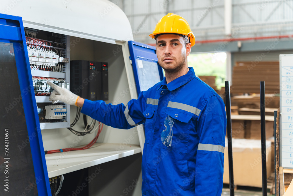 © chokniti - Professional male caucasian engineer or manufacturing worker man person in factory portrait, smart industry business manager occupation job with safety helmet for construction work, machinery foreman