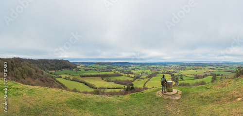backpacker hiker on the high ground of Coaley Peak, Stroud, Gloucestershire, UK photo