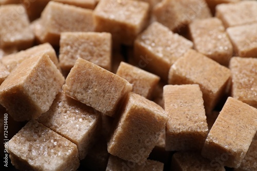 Many brown sugar cubes as background, closeup