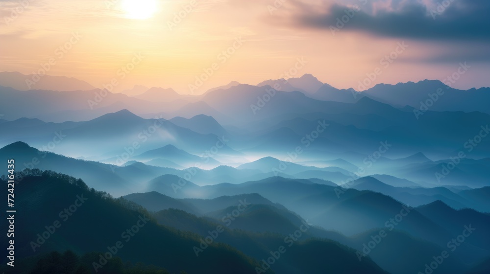 Obraz premium Beautiful rocky mountainous landscape at orange dawn with sun through the clouds