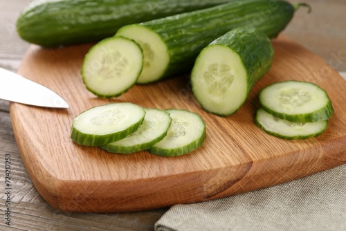 Cucumbers. knife and cutting board on table, closeup