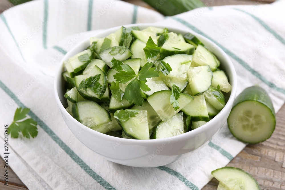 Delicious cucumber salad in bowl on table Delicious cucumber salad in bowl on table