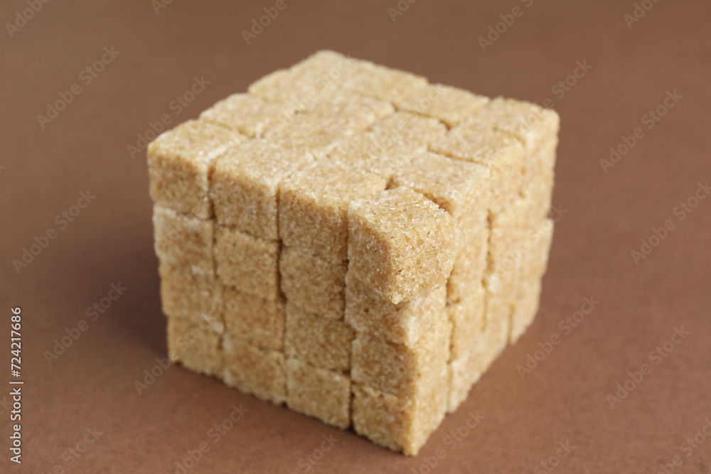 Brown sugar cubes on color background, closeup Brown sugar cubes on color background, closeup