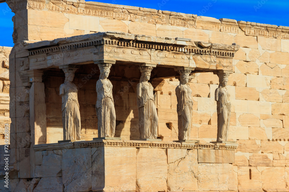 Fototapeta premium The Caryatid porch of Erechtheion (Erechtheum) or Temple of Athena Polias is an ancient Greek Ionic temple on the north side of the Acropolis in Athens, Greece
