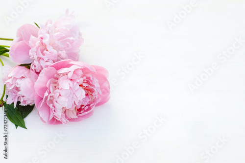 Fototapeta Naklejka Na Ścianę i Meble -  Bouquet of pink peonies on a white wooden background.