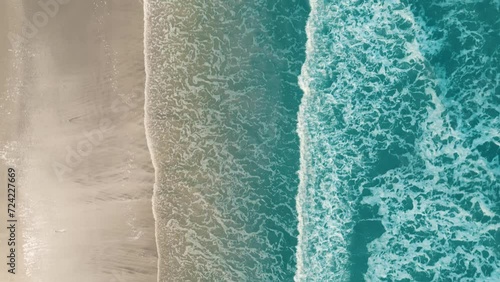 Drone aerial view of paradise beach. Turquoise sea water and clear sand at sunset.