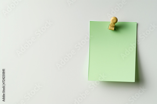 one Green colored sticky note pinned on a white background, Empty blank note paper stick on white board, pinned Reminder memo isolated on flat wall, Green color blank sheet paper on white background