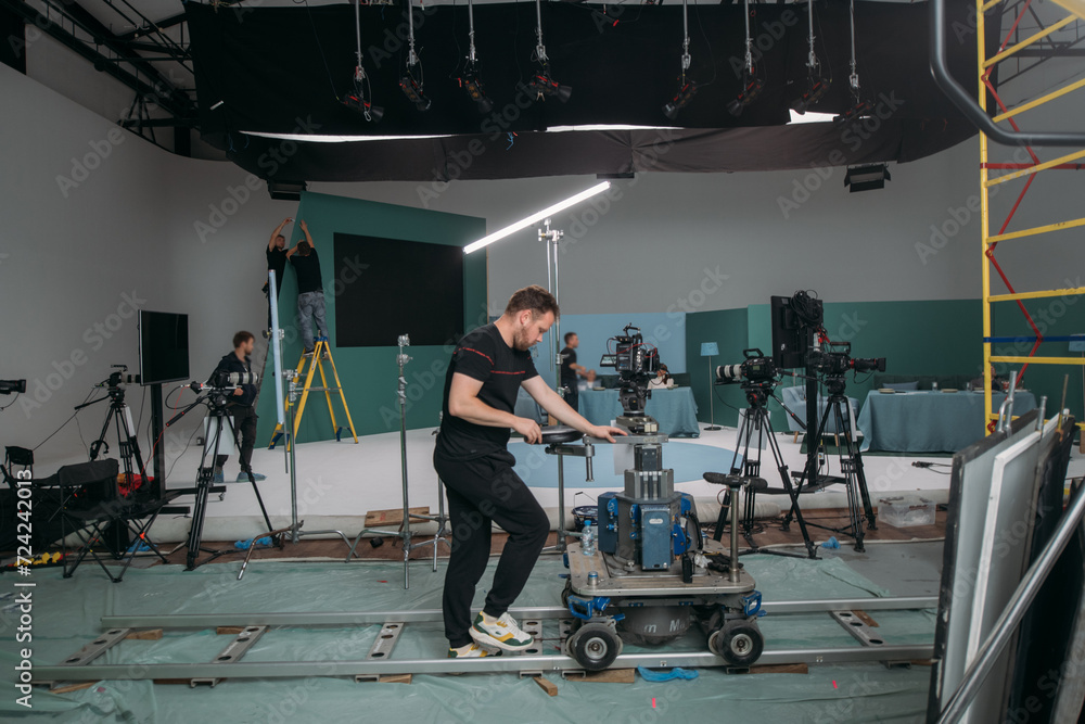 Obraz premium Film set, monitors and modern shooting equipment. Film crew, lighting devices, monitors, playbacks - filming equipment and a team