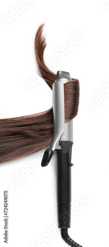 Curling iron with brown hair lock on white background, top view