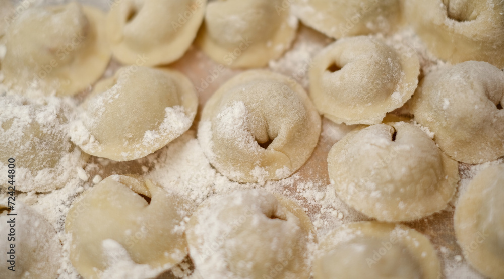 A pile of dumplings with flour on the table