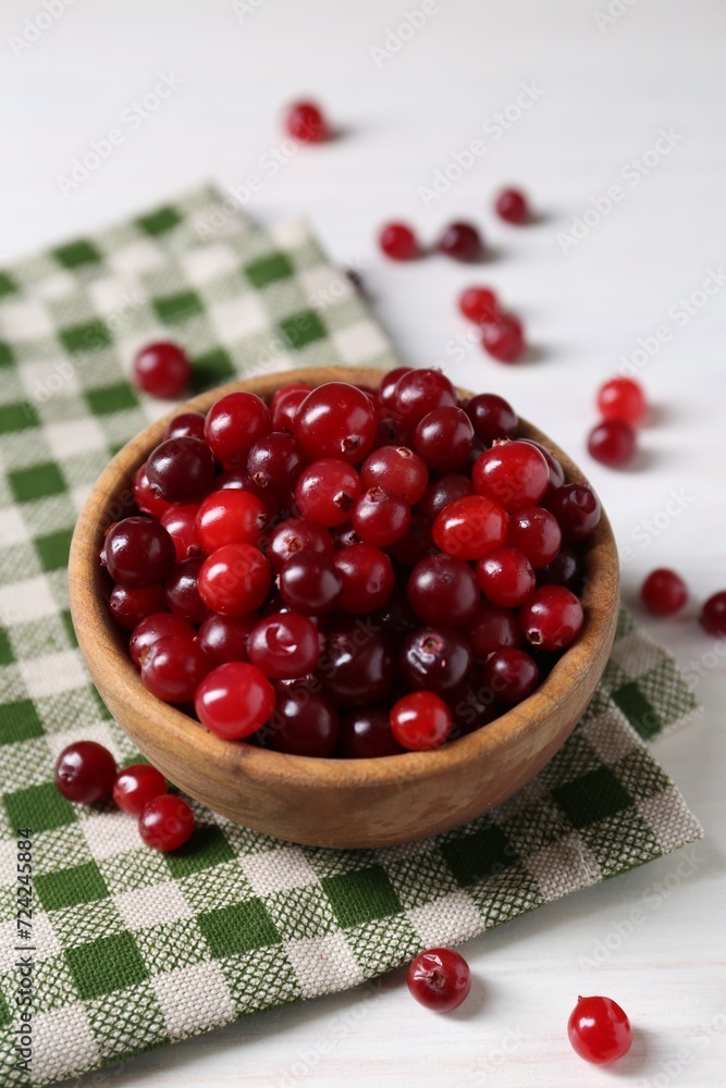 Fresh ripe cranberries in bowl on white table Fresh ripe cranberries in bowl on white table