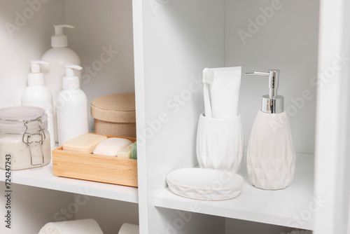 Different personal care products and bath accessories in bathroom vanity