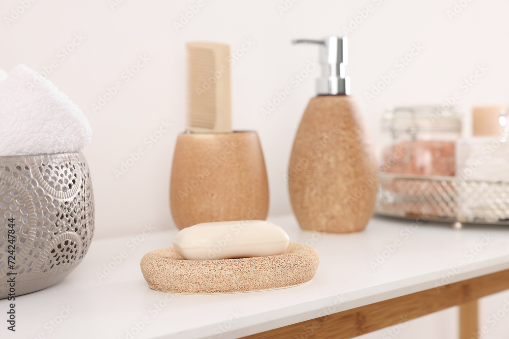 Different bath accessories and personal care products on table near white wall Different bath accessories and personal care products on table near white wall