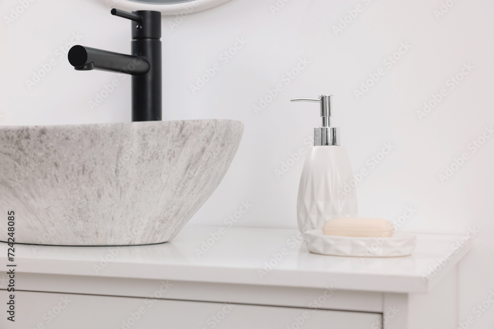 Different bath accessories and personal care products on bathroom vanity indoors Different bath accessories and personal care products on bathroom vanity indoors