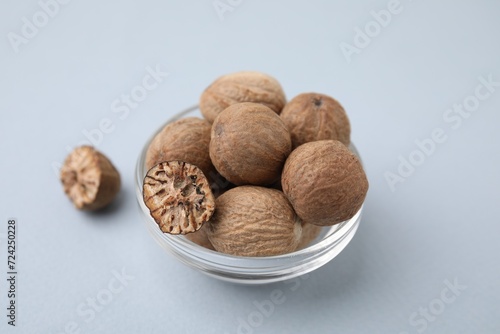 Nutmegs in glass bowl on white background