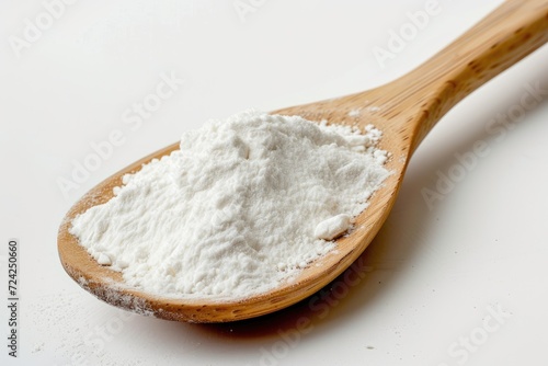 Tapioca starch or flour powder in spoon white background photo