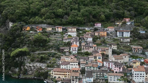 A city on the water's edge. A small Italian town. A tourist village by the river. Italy. Switzerland. Como. Gandria. Fishing village. European town. A town on a rock. Village on a cliff near the water