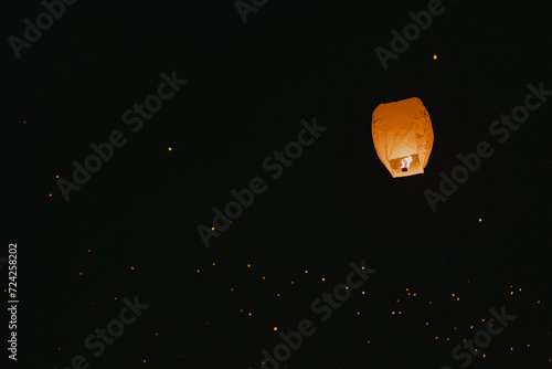 Sky lantern soaring in a starry night ambiance photo