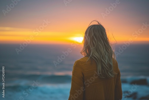 Woman admiring the seascape during sunrise