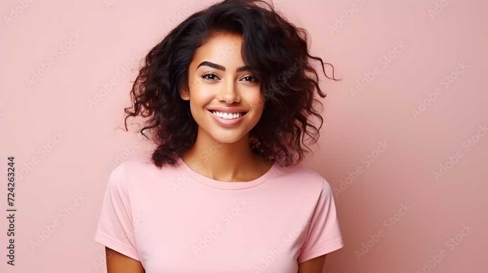 Beautiful woman with an afro hairstyle on peach studio background Beautiful woman with an afro hairstyle on peach studio background