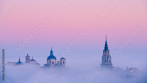Foggy sunrise over historical buildings